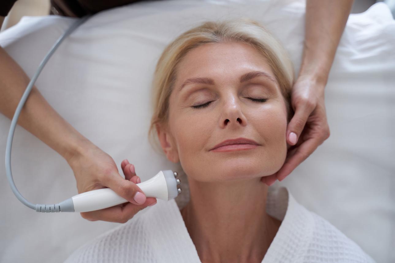 A woman relaxing with her eyes closed during a skin treatment