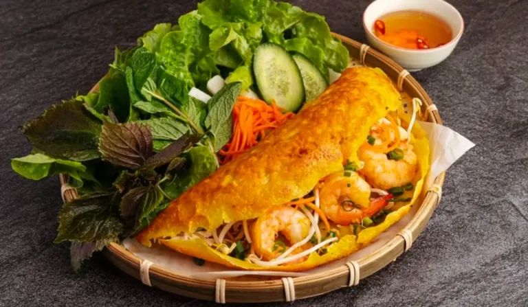 Crispy banh xeo pancakes with fresh herbs