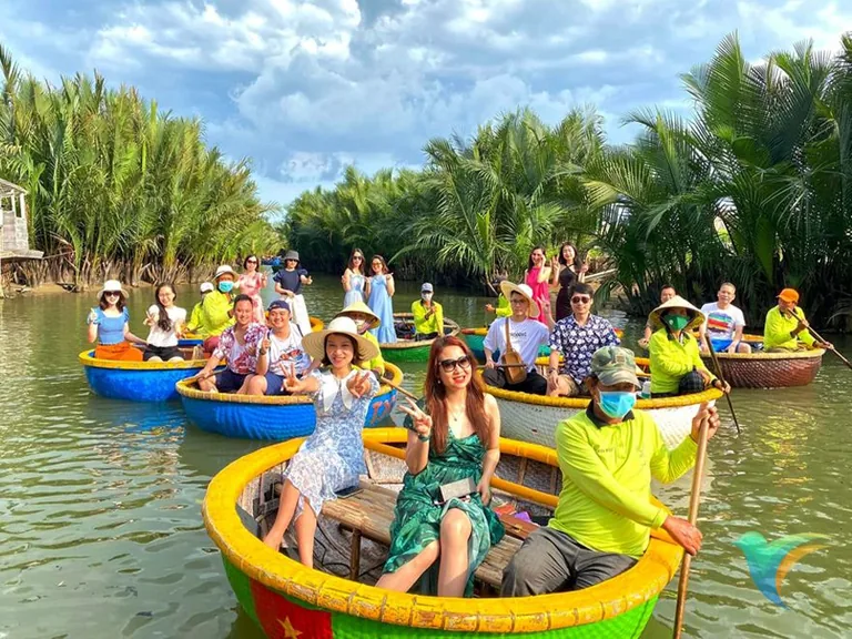 Blooming Passage guests in coconut basket boats near Hoi An