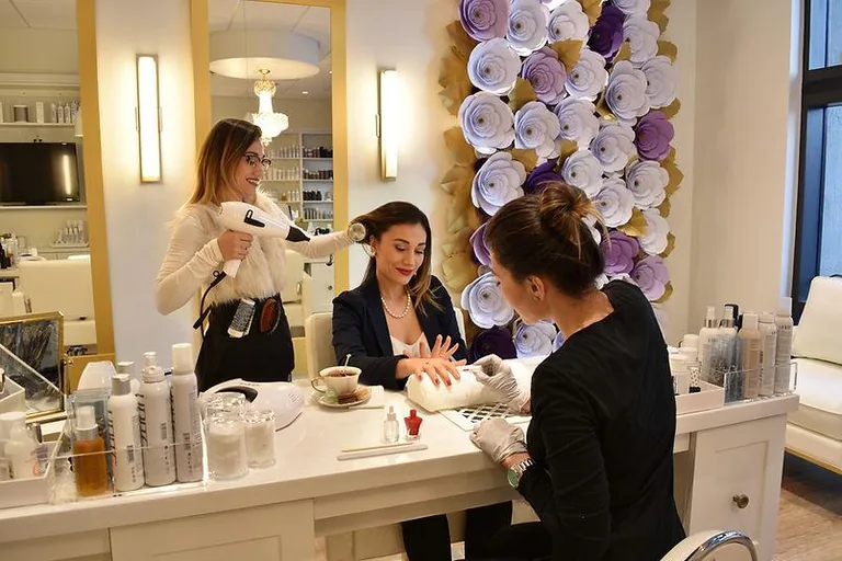 Blooming Passage guests enjoying a hair and beauty session at a salon