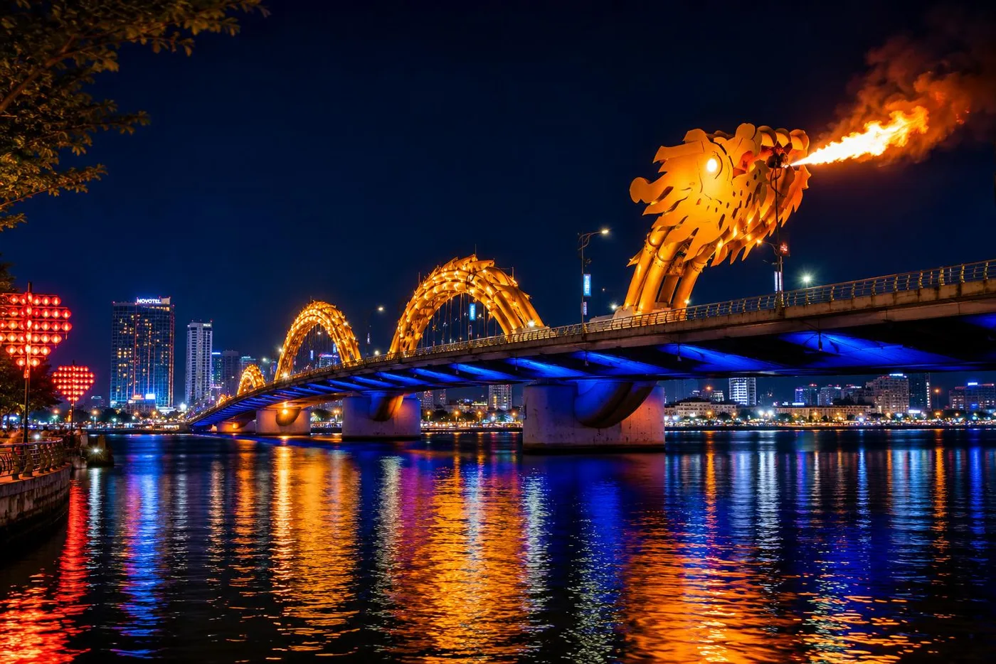 The Dragon Bridge breathing fire above the glowing Han River at night