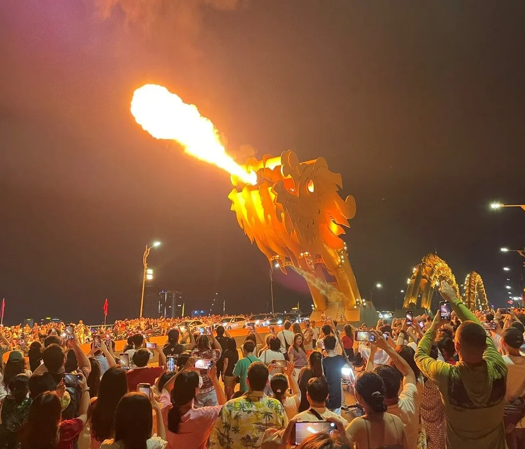 Crowds filming the Dragon Bridge as it breathes fire at night