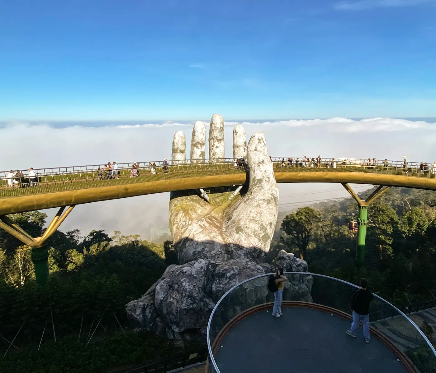 The Golden Bridge held by stone hands above the clouds at Ba Na Hills