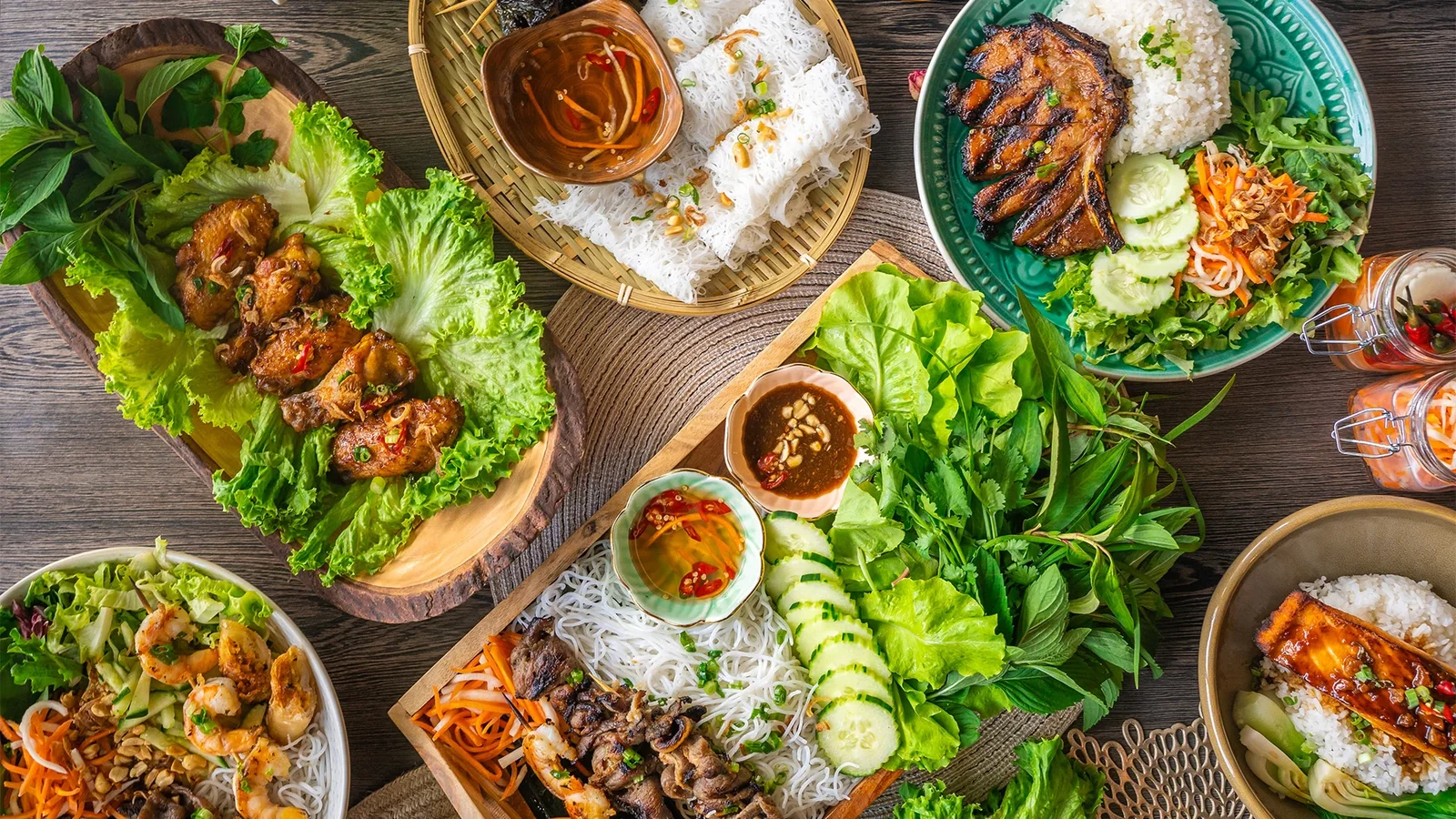 A table spread of Vietnamese dishes, from pho to fresh spring rolls