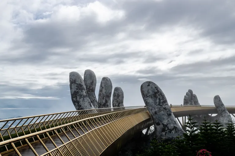 The Golden Bridge held up by giant stone hands at Ba Na Hills