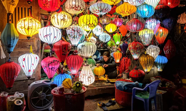 Artisans crafting silk lanterns in a Hoi An lantern workshop