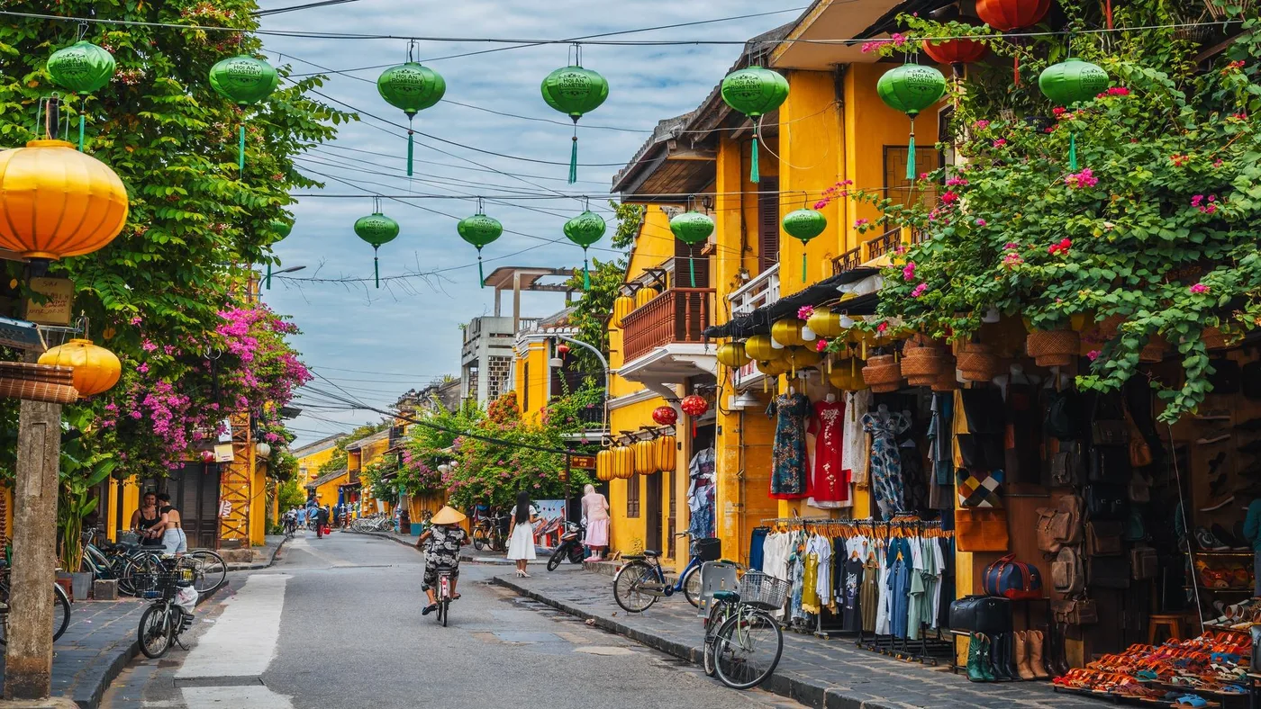 Silk lanterns strung above a yellow-walled street in Hoi An Ancient Town