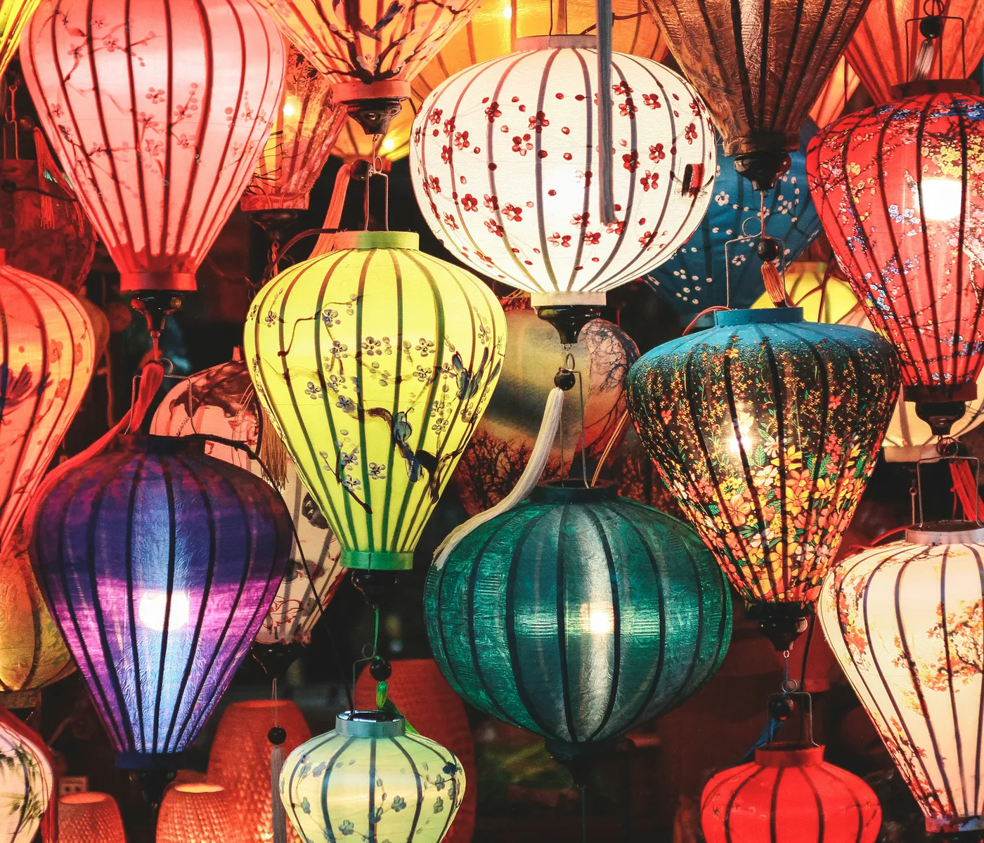 Silk lanterns glowing in red, gold and green