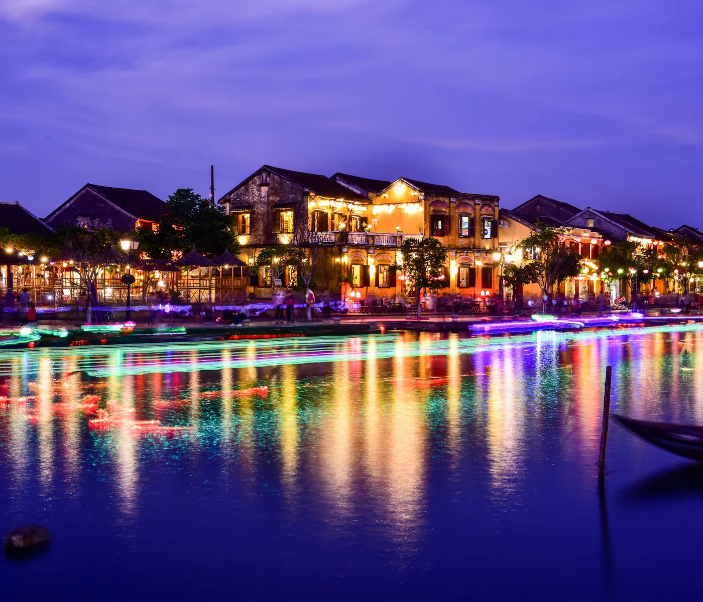 The old town reflected in the Thu Bon River at blue hour