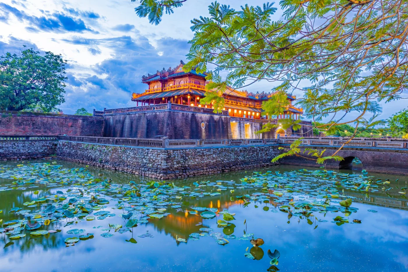 The Ngo Mon Gate of the Hue Imperial City above a moat full of lotus leaves