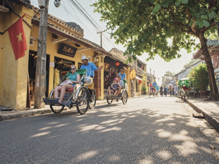 A cyclo ride along a sunlit street in Hoi An Ancient Town