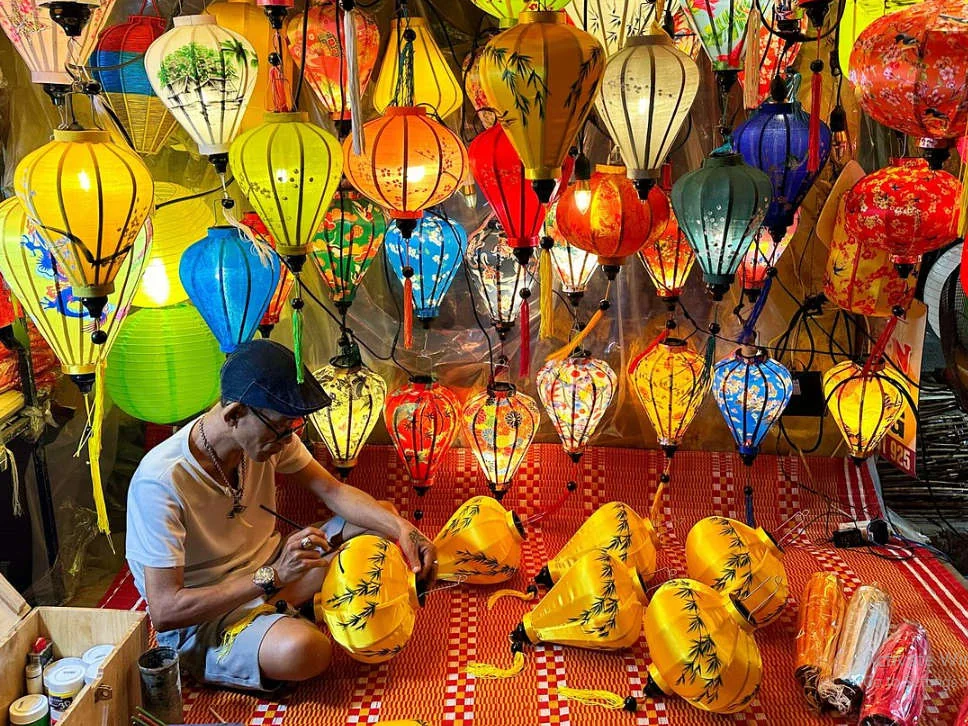 A craftsman building silk lanterns in a Hoi An workshop
