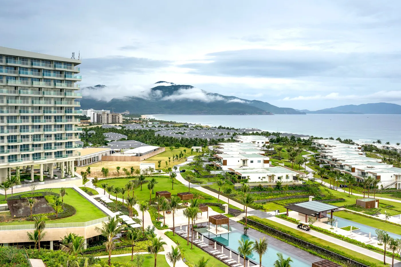 A beachfront resort with tropical gardens and pools along the Da Nang coast